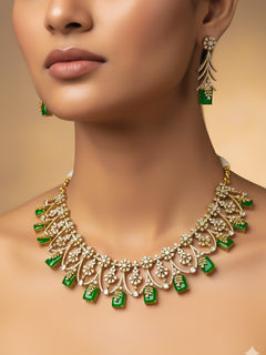 "A stunning woman wearing a glamorous artificial diamond and emerald green colored stone designer necklace paired with chic earrings, perfect for bridal wear. This high-quality artificial diamond jewelry set is the ideal choice for modern brides looking for a budget-friendly option with timeless sparkle."