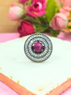 Close-up of an ornate Western (Black Polish Victorian Finish) Red Diamond Ring with American Diamond and Colored Stones. A premium imitation American Diamond ring with festive attire. Party wear styling with a premium imitation jewelry American Diamond ring.