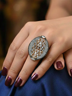 Close-up of a woman wearing an ornate Indo-Western (Black Polish) Diamond Ring with American Diamonds. Close-up of an American diamond cocktail ring for party wear in India. Bride wearing a Cocktail artificial American Diamond ring for her wedding reception.