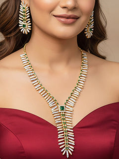 Close-up of a woman wearing an ornate Indo-western gold jewellery set and earrings with American Diamonds and Green Colored Stones. Close-up of a cocktail party look featuring a premium American diamond necklace. Bride-to-be styled in a premium American diamond artificial necklace for her reception party.