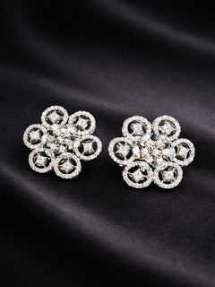 Close-up of an ornate Western (Silver Polish) Diamond Studs Earrings with American Diamond. Festive Diwali outfit styled with an American diamond artificial Earrings. Close-up shot of a high-quality American diamond artificial Earrings worn for festive celebrations.