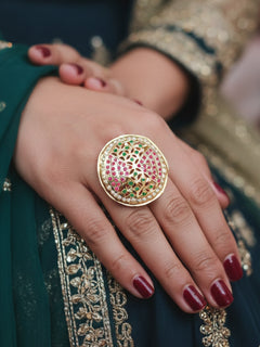 Close-up of a woman wearing an ornate traditional Multi-Color jadau gold Ring with pearl and Color Stone. Woman styling a premium imitation jadau ring with festive attire. Close-up of a high-quality imitation jadau ring with intricate detailing.