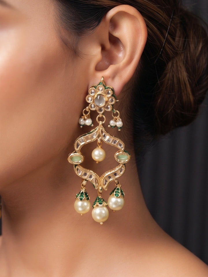 Close-up of Kundan chandelier earring with mint green stones and cream pearl drop fringe
