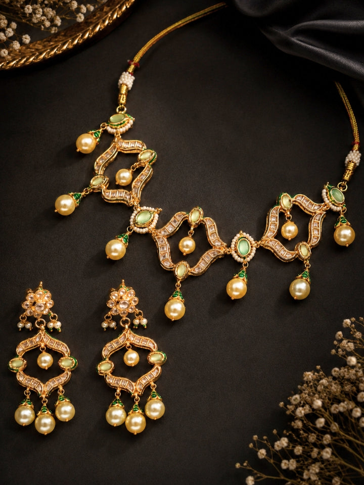 Green Kundan necklace set with meenakari enamel caps and pearl drops on a dark background
