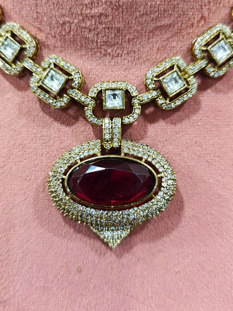 An exquisite artificial diamond and polki with red colored stone necklace and matching earrings, designed for the perfect engagement look. This stunning artificial diamond jewelry set offers luxury and sophistication while being an affordable alternative to natural diamonds.
