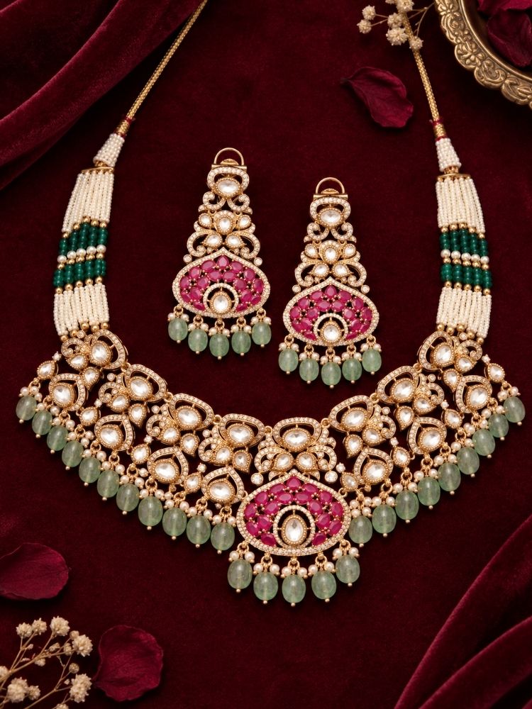 Rosabel Necklace Set with earrings on fabric – a polki choker with pearl and green bead strands and a ruby pink fan pendant, traditional jewellery set for women
