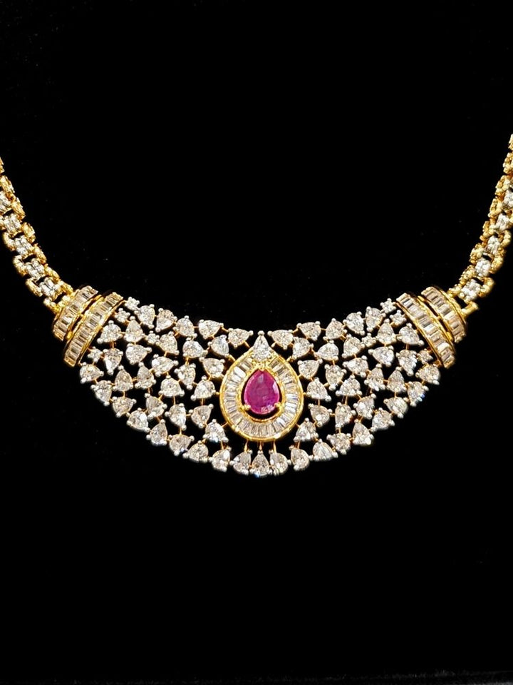 Close-up o an ornate Western (Silver Polish) Pink Collar jewellery set and earrings with Pink Colored Stone and American Diamond.Woman styling a statement American diamond necklace with an off-shoulder gown for a reception. Party wear outfit completed with a lightweight American diamond necklace.