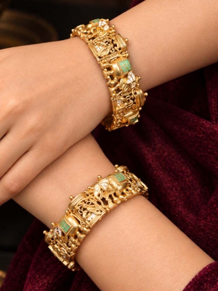 Muziri Bangle Set – woman wearing antique gold temple bangles with mint green stones on both wrists, traditional bangles for wedding and festive wear