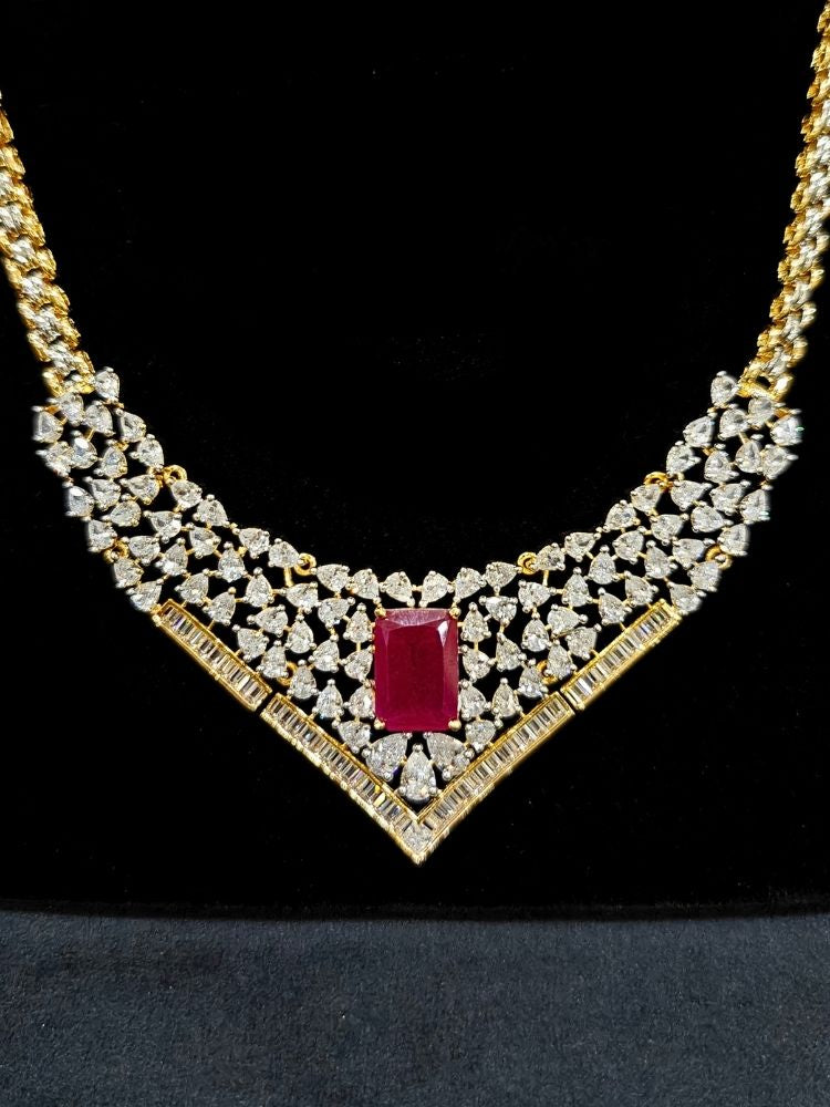 Close-up of an ornate Western (Silver Polish) Pink Collar jewellery set and earrings with Pink Colored Stone and American Diamond. Woman styling a statement American diamond necklace with an off-shoulder gown for a reception. Party wear outfit completed with a lightweight American diamond necklace.