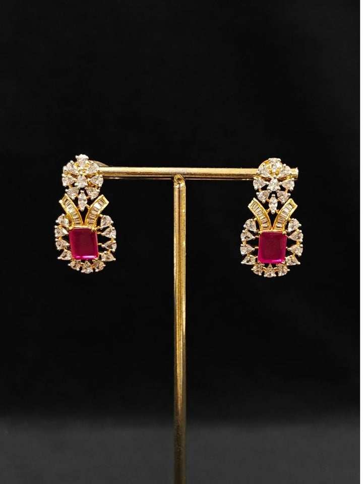 Close-up of an ornate Western (Silver Polish) Pink Collar jewellery set and earrings with Pink Colored Stone and American Diamond. Woman styling a statement American diamond necklace with an off-shoulder gown for a reception. Party wear outfit completed with a lightweight American diamond necklace.