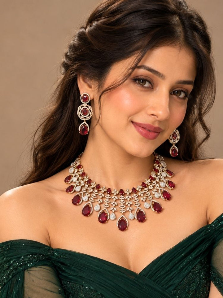 Woman wearing the Chantilly Necklace Set – a silver-tone American diamond collar necklace with ruby red teardrop stones, jewellery for reception, sangeet and parties