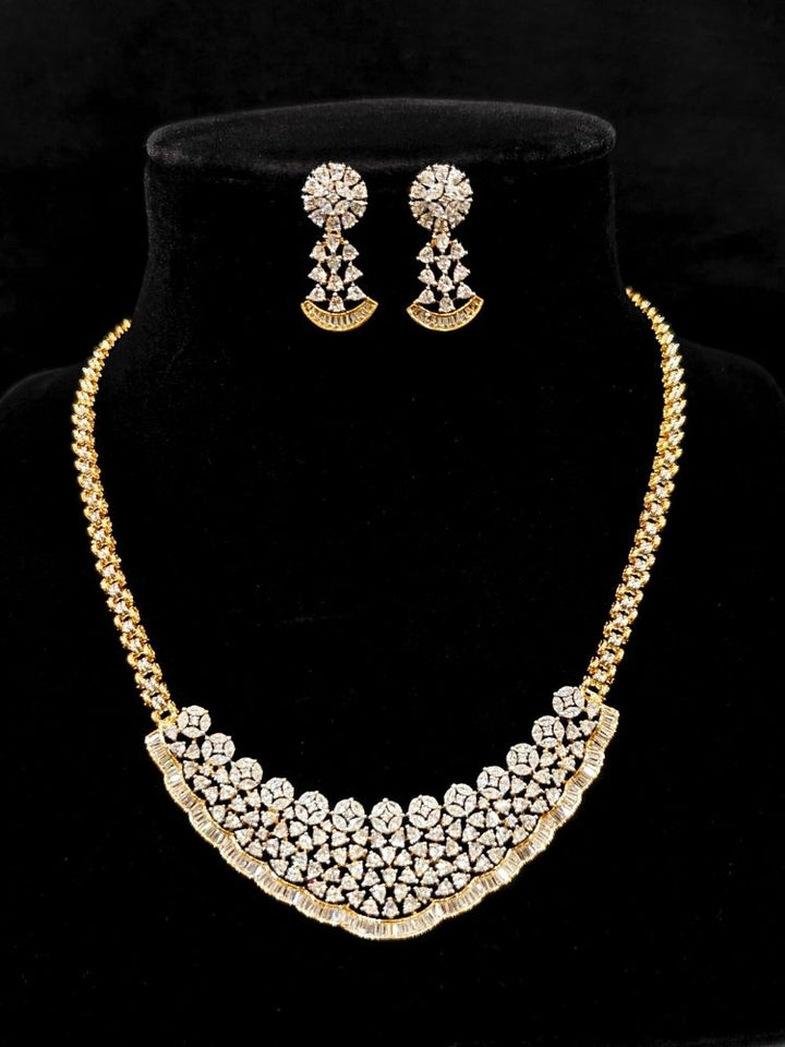 Close-up of  an ornate Western (Silver Polish) Collar jewellery set and earrings with American Diamond. Party wear outfit completed with a lightweight American diamond necklace. Reception-ready look featuring a American diamond jewelry set.