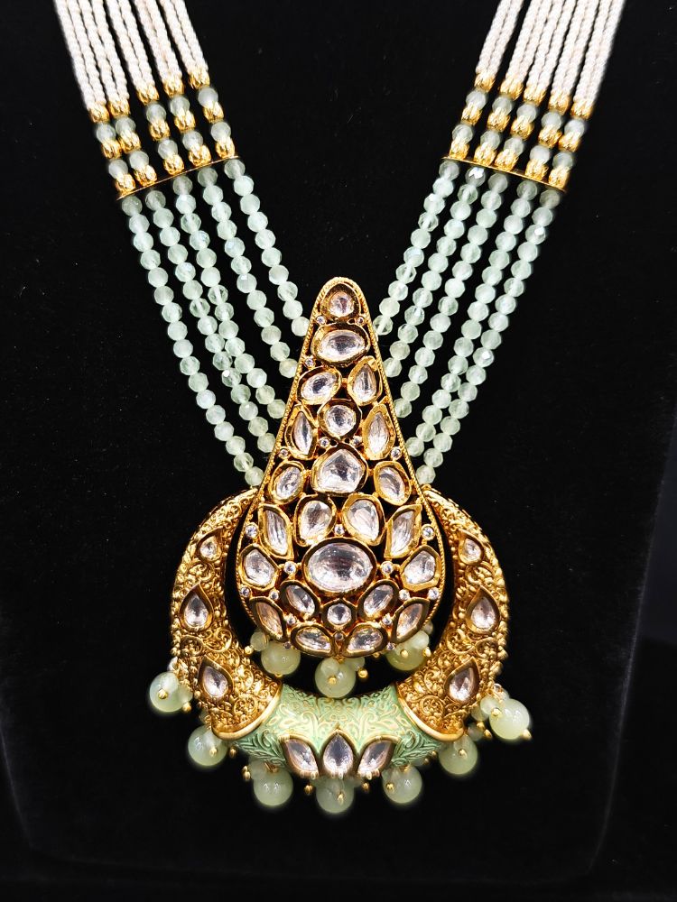 Close-up of an ornate traditional (Gold Polish) Mint Green Long jewellery set and earrings with Polki, Crystal Beads, Meenakari and Pearls. Festive Diwali look enhanced with a premium Polki artificial necklace. Saree styling inspiration with a Long Polki imitation jewelry piece.