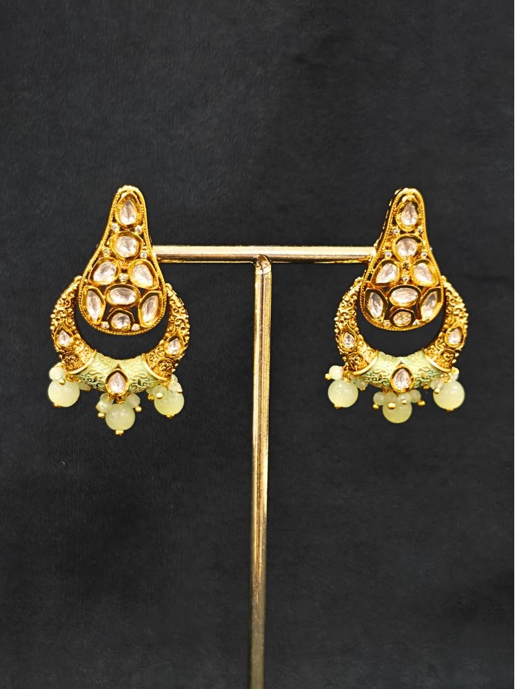 Close-up of an ornate traditional (Gold Polish) Mint Green Long jewellery set and earrings with Polki, Crystal Beads, Meenakari and Pearls. Festive Diwali look enhanced with a premium Polki artificial necklace. Saree styling inspiration with a Long Polki imitation jewelry piece.