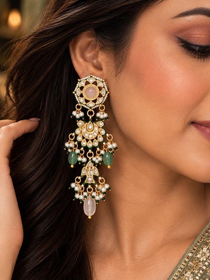 Close-up of a long Kundan chandelier earring with blush pink centre stone and mint green beads