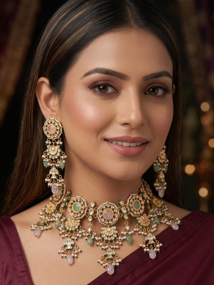 Woman wearing a pastel Kundan choker necklace set with matching long chandelier earrings