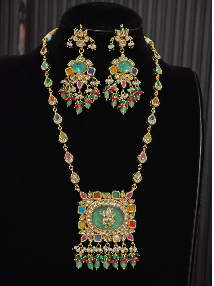 Close-up of Navratan Kundan chandelier earring with mint green stone and ruby bead drops