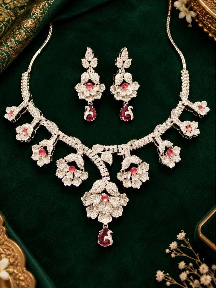 Oleander American Diamond Red Silver Tone Necklace Set with earrings on fabric – a silver-tone American diamond floral necklace with ruby red drops, traditional jewellery set for women