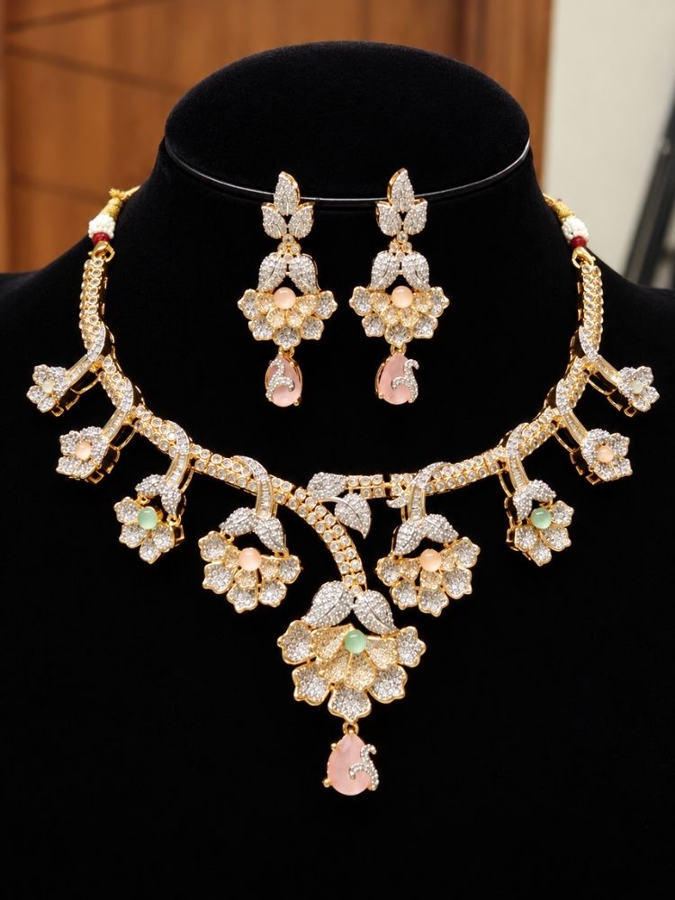 Oleander American Diamond Mint Pink & Green Dual Tone Necklace Set on display – a dual tone American diamond floral necklace with mint pink and green stones, with matching earrings, premium artificial jewellery online