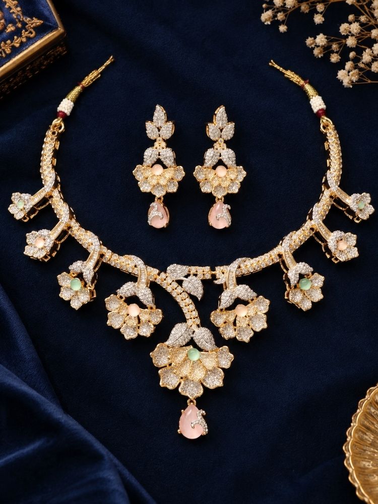 Oleander American Diamond Mint Pink & Green Dual Tone Necklace Set with earrings on fabric – a dual tone American diamond floral necklace with mint pink and green stones, traditional jewellery set for women