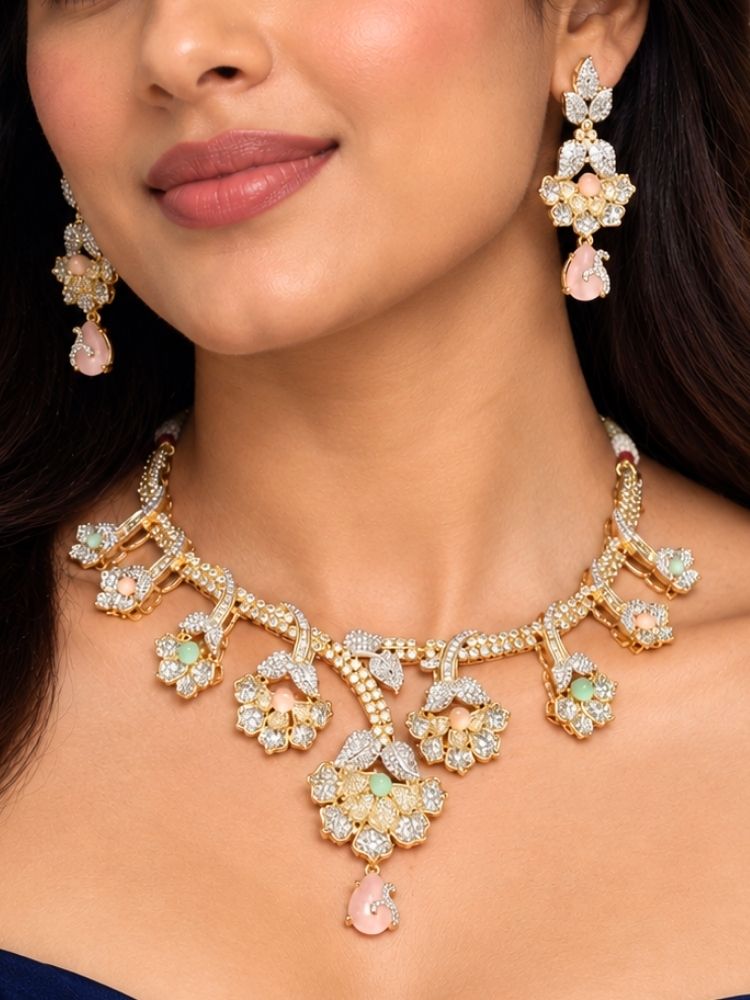 Oleander American Diamond Mint Pink & Green Dual Tone Necklace Set – woman wearing a dual tone American diamond floral necklace with mint pink and green stones and matching earrings, styled with a navy off-shoulder dress, artificial jewellery for engagement, sangeet and reception