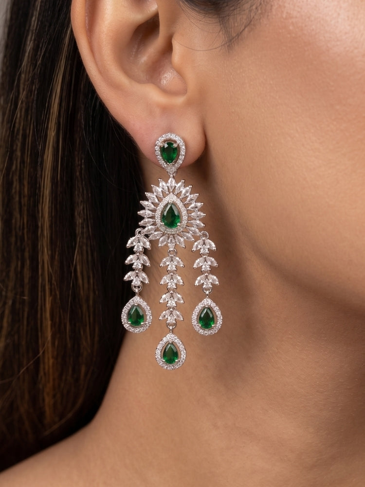 Close-up of a woman wearing an ornate Western (Silver Polish) Diamond Green Choker jewellery set and earrings with American Diamond and Green Colored Stones. Woman styling a statement American diamond necklace with an off-shoulder gown for a reception. A graceful woman wearing a trending American diamond necklace for a 2026 wedding celebration.