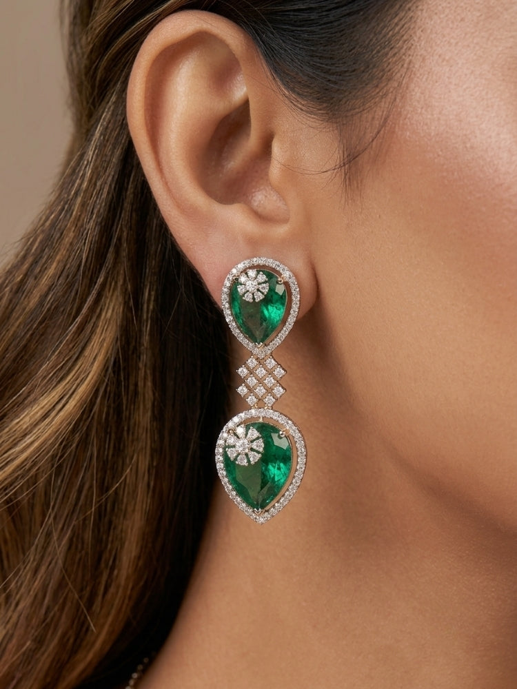 Close-up of a woman wearing an ornate Western (Silver Polish) Diamond Green Collar jewellery set and earrings with American Diamond and Green Colored Stones. Close-up shot of a high-quality American diamond artificial necklace worn for festive celebrations. Party wear outfit completed with a lightweight American diamond necklace.