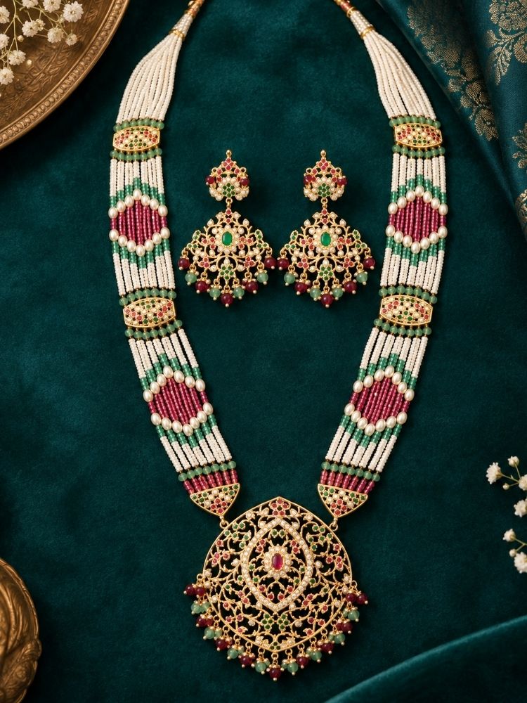 Suhana Jadau Necklace Set on display – a long jadau necklace with ruby red, green and pearl bead strands and a jadau pendant, with matching earrings, premium artificial jewellery online