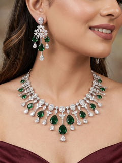 Close-up of a woman wearing an ornate Western (Silver Polish) Diamond Green Collar jewellery set and earrings with American Diamond and Green Colored Stone. Party wear outfit completed with a lightweight American diamond necklace.
Elegant wedding jewelry look featuring a premium artificial American diamond necklace.