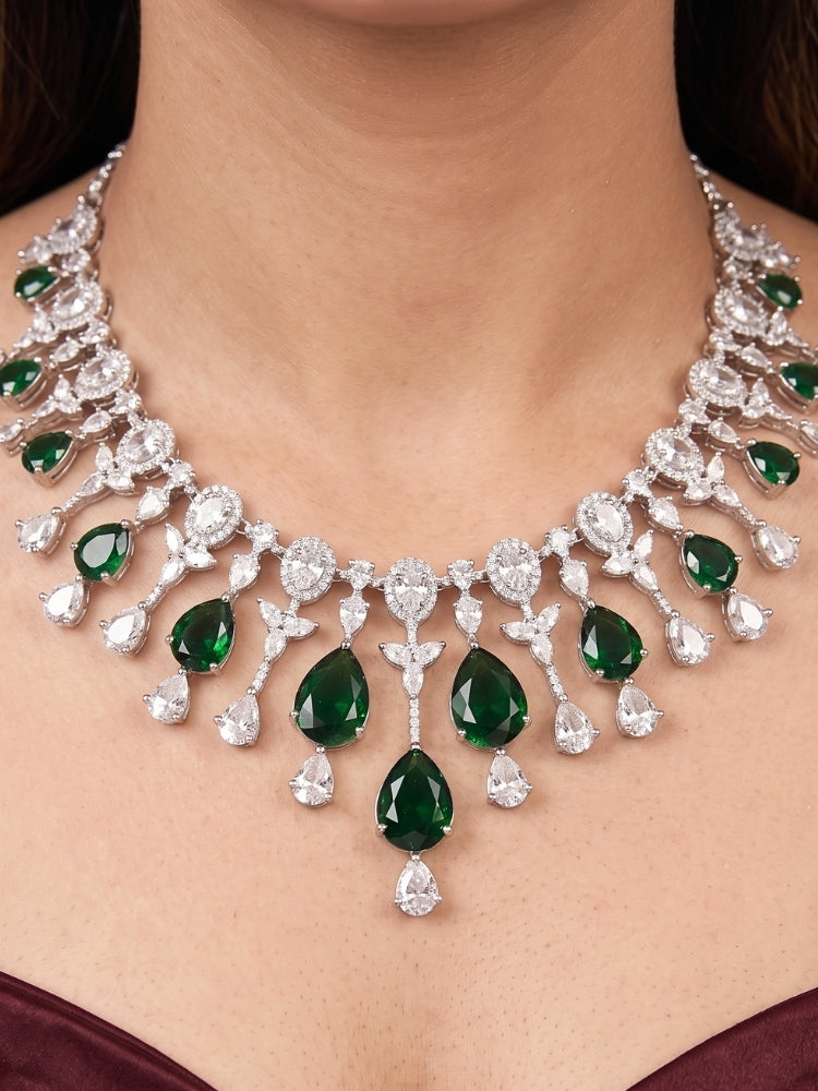 Close-up of a woman wearing an ornate Western (Silver Polish) Diamond Green Collar jewellery set and earrings with American Diamond and Green Colored Stone. Party wear outfit completed with a lightweight American diamond necklace.
Elegant wedding jewelry look featuring a premium artificial American diamond necklace.