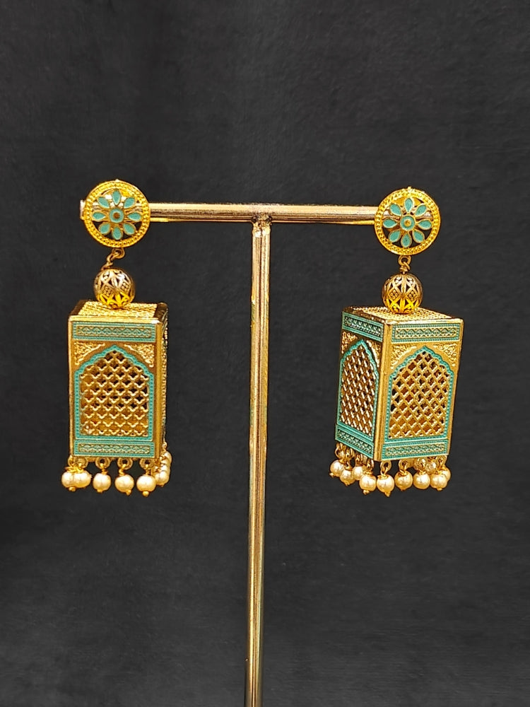 Close-up of an ornate traditional Mint Green Rajwadi gold Long jewellery set and earrings  with  Pearls and Meenakari. Festive Diwali outfit enhanced with a Rajwadi artificial necklace. Close-up of detailed Rajwadi craftsmanship in artificial jewelry. Close-up of enamel work in Meenakari artificial wedding jewelry.