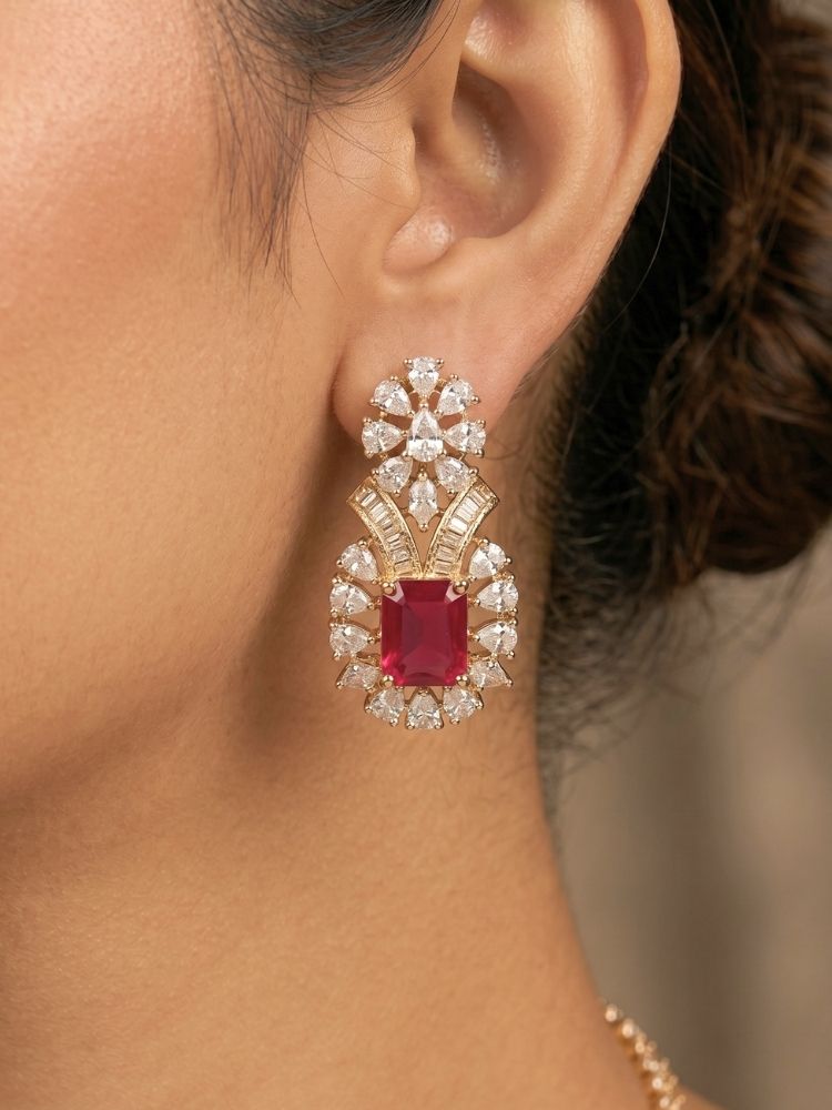 Close-up of a woman wearing an ornate Western (Silver Polish) Pink Collar jewellery set and earrings with Pink Colored Stone and American Diamond. Woman styling a statement American diamond necklace with an off-shoulder gown for a reception. Party wear outfit completed with a lightweight American diamond necklace.