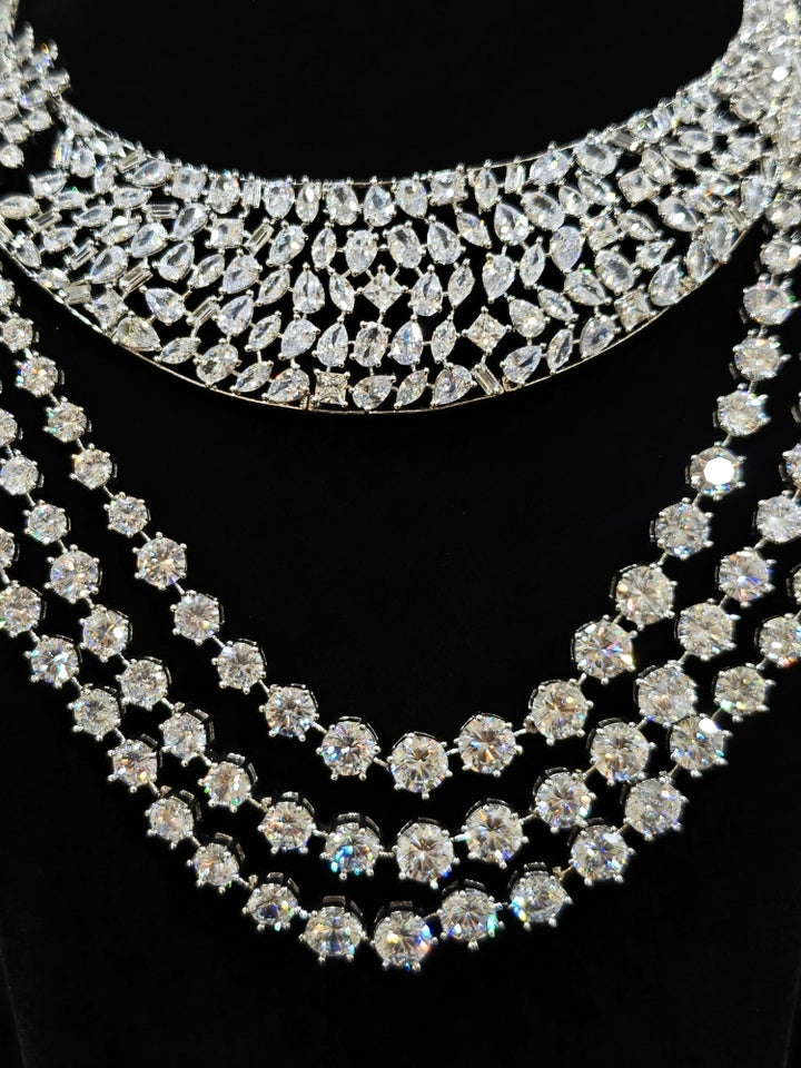 Close-up of an ornate Western (Silver Polish) Layered jewellery set and earrings with American Diamond and Champaign Colored Stones. Elegant wedding jewelry look featuring a premium artificial American diamond necklace. A graceful woman wearing a trending American diamond necklace for a 2026 wedding celebration.