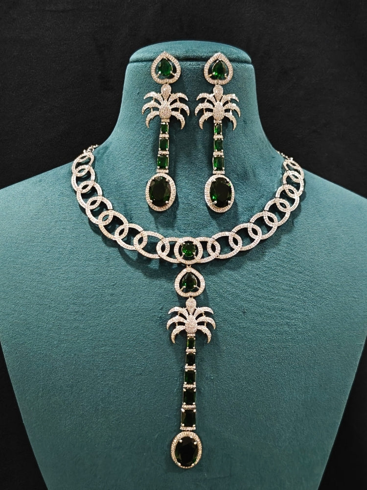 Close-up of an ornate Western (Silver Polish) Collar jewellery set and earrings with American Diamond and Green Colored Stones. Party wear outfit completed with a lightweight American diamond necklace. Model wearing a lightweight American diamond necklace perfect for long wedding functions.
Close-up of a bridal look featuring an anti-tarnish American diamond artificial necklace.