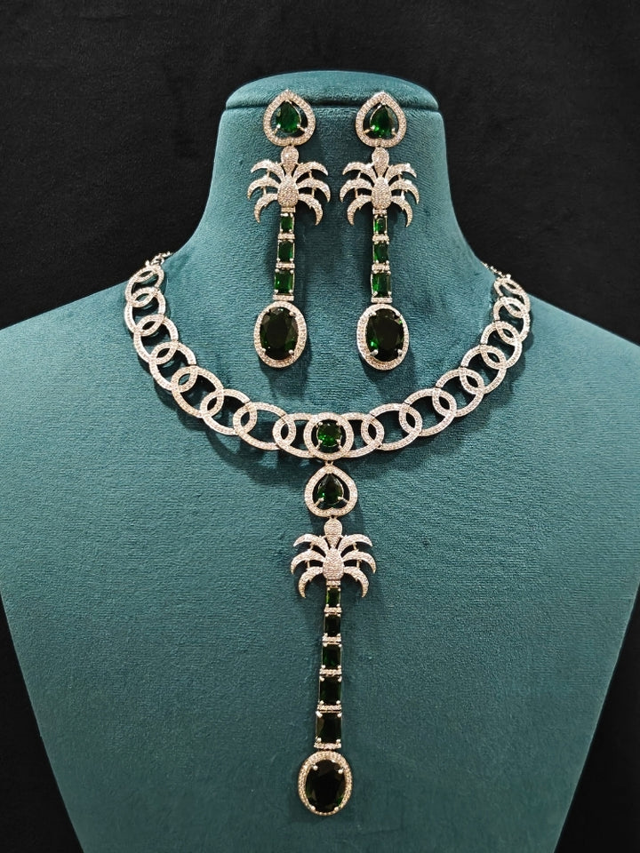 Close-up of an ornate Western (Silver Polish) Collar jewellery set and earrings with American Diamond and Green Colored Stones. Party wear outfit completed with a lightweight American diamond necklace. Model wearing a lightweight American diamond necklace perfect for long wedding functions.
Close-up of a bridal look featuring an anti-tarnish American diamond artificial necklace.