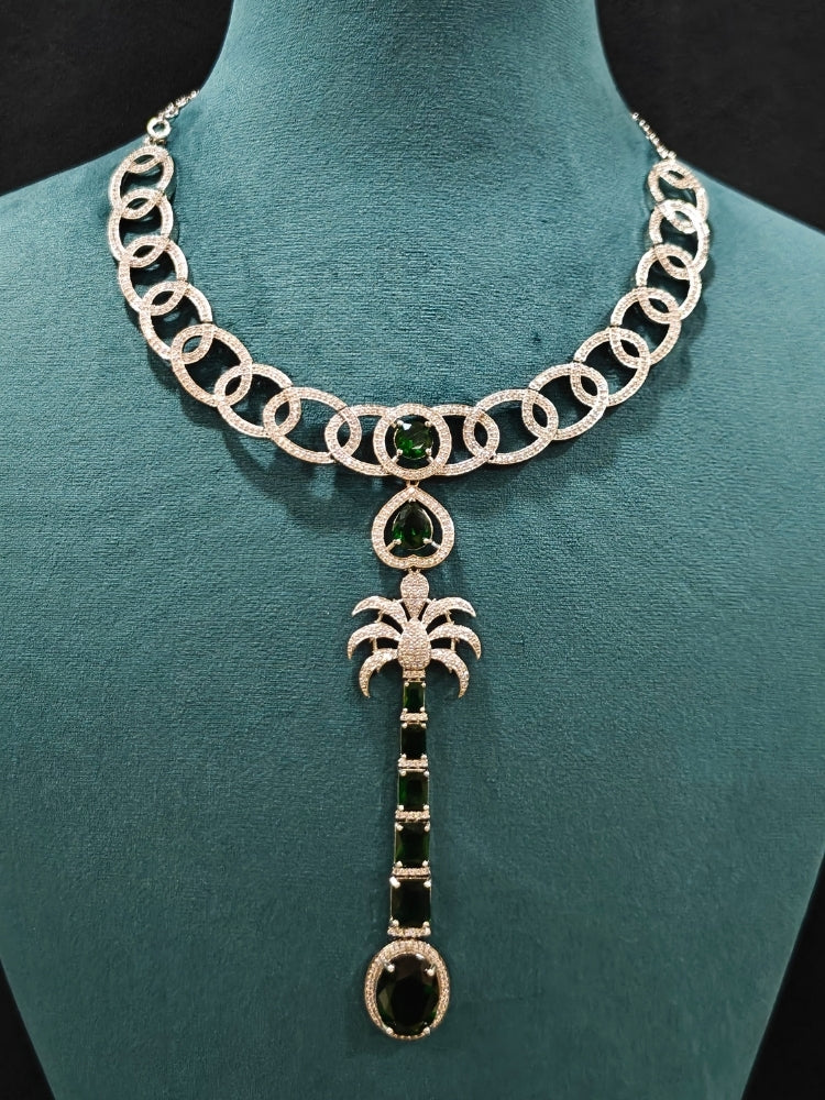 Close-up of an ornate Western (Silver Polish) Collar jewellery set and earrings with American Diamond and Green Colored Stones. Party wear outfit completed with a lightweight American diamond necklace. Model wearing a lightweight American diamond necklace perfect for long wedding functions.
Close-up of a bridal look featuring an anti-tarnish American diamond artificial necklace.