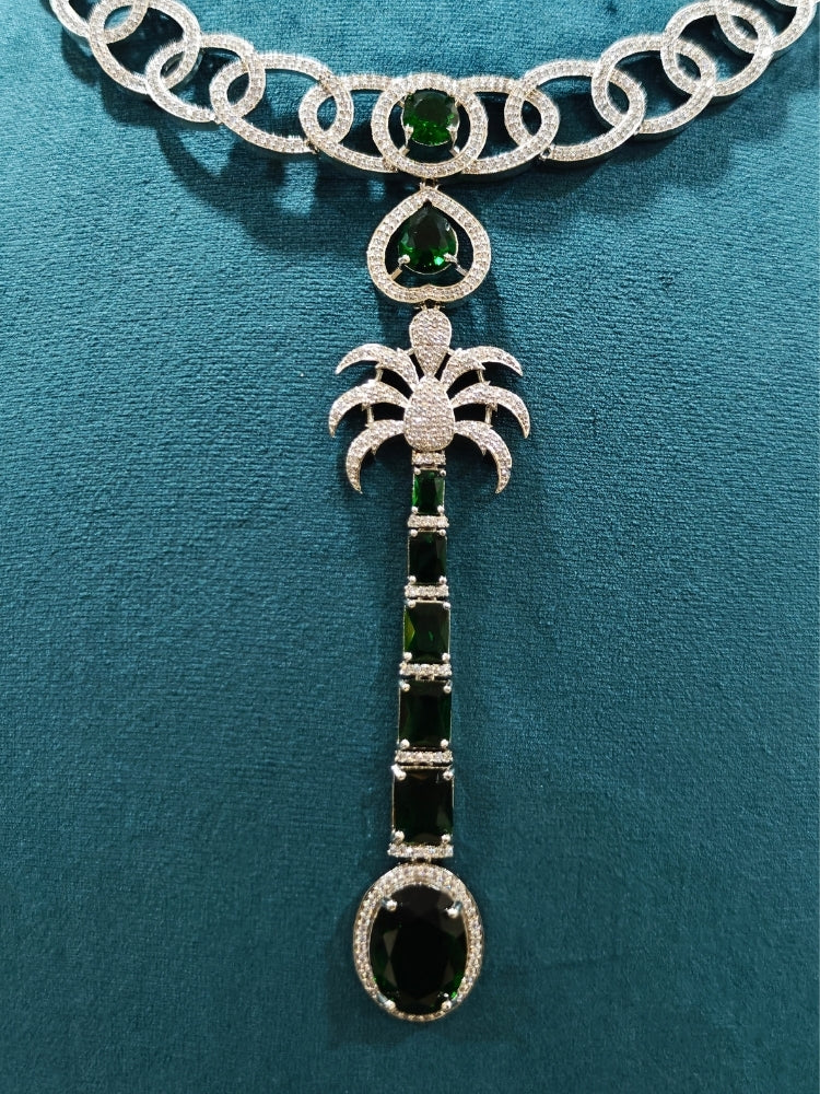 Close-up of an ornate Western (Silver Polish) Collar jewellery set and earrings with American Diamond and Green Colored Stones. Party wear outfit completed with a lightweight American diamond necklace. Model wearing a lightweight American diamond necklace perfect for long wedding functions.
Close-up of a bridal look featuring an anti-tarnish American diamond artificial necklace.