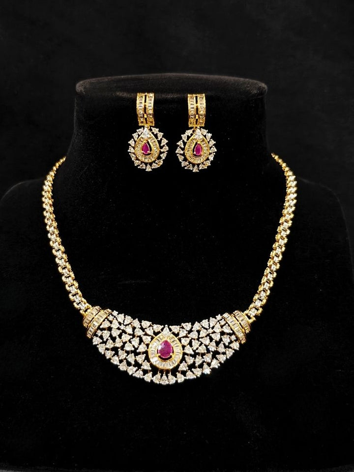 Close-up o an ornate Western (Silver Polish) Pink Collar jewellery set and earrings with Pink Colored Stone and American Diamond.Woman styling a statement American diamond necklace with an off-shoulder gown for a reception. Party wear outfit completed with a lightweight American diamond necklace.