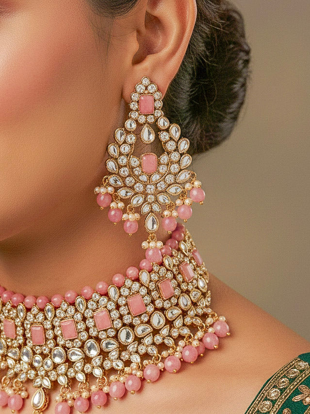 Close-up of a woman wearing an ornate traditional Pink Kundan Choker jewellery set and earrings and maangtikka with Kundan, Mint Pink Stone, Pearls and Mint Pink Crystal Beads. Bride wearing a royal Kundan artificial necklace for wedding rituals. Wedding celebration look enhanced with a statement Kundan necklace. 