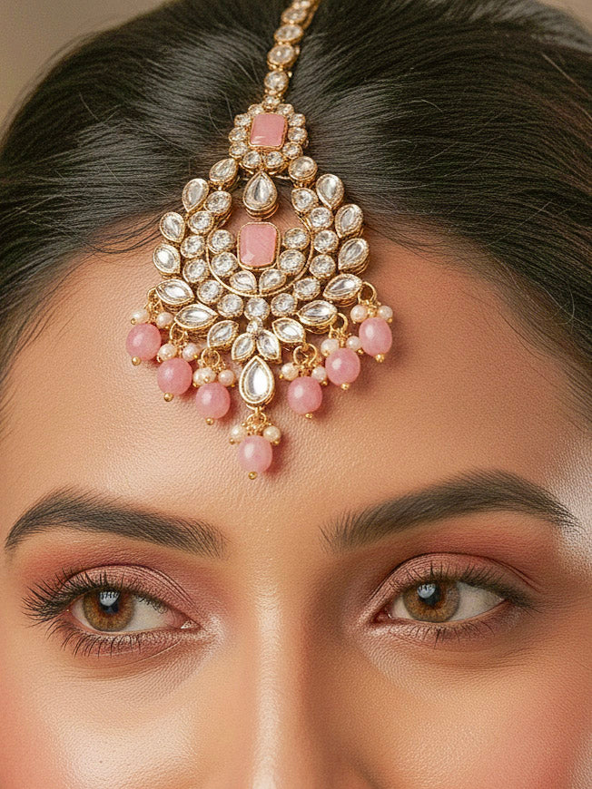 Close-up of a woman wearing an ornate traditional Pink Kundan Choker jewellery set and earrings and maangtikka with Kundan, Mint Pink Stone, Pearls and Mint Pink Crystal Beads. Bride wearing a royal Kundan artificial necklace for wedding rituals. Wedding celebration look enhanced with a statement Kundan necklace. 