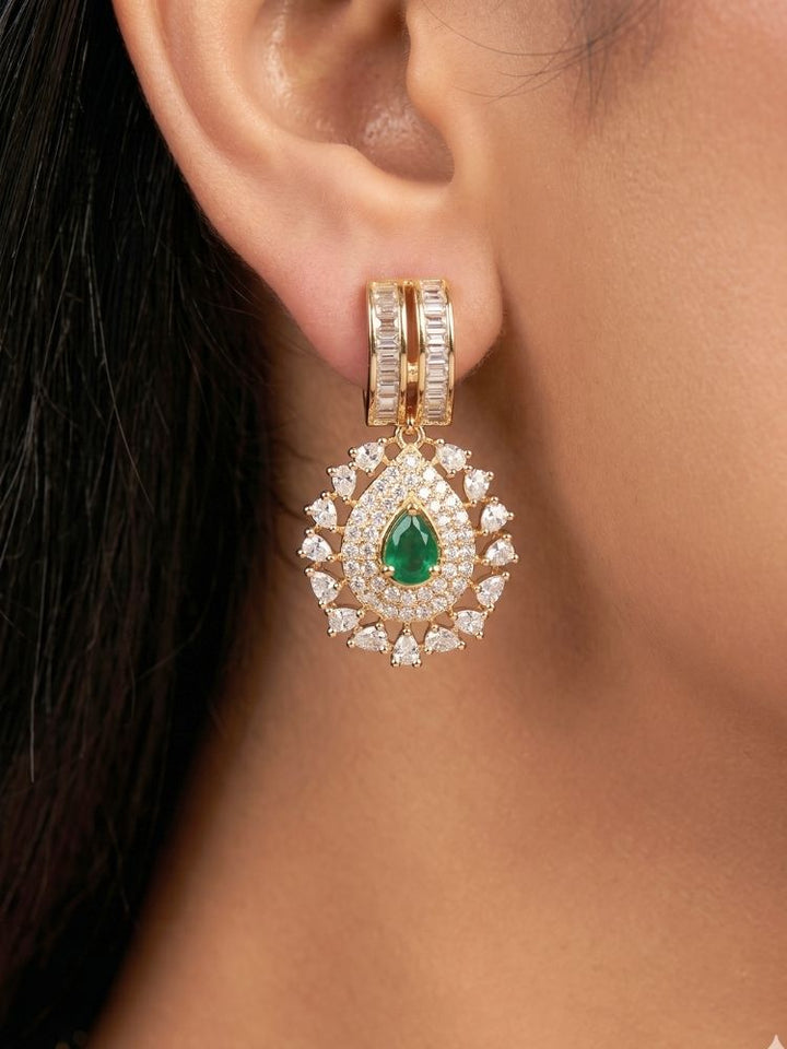Close-up of a woman wearing an ornate Western (Silver Polish) Green Collar jewellery set and earrings with Green Colored Stone and American Diamond.Woman styling a statement American diamond necklace with an off-shoulder gown for a reception. Party wear outfit completed with a lightweight American diamond necklace.
