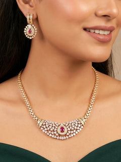 Close-up of a woman wearing an ornate Western (Silver Polish) Pink Collar jewellery set and earrings with Pink Colored Stone and American Diamond.Woman styling a statement American diamond necklace with an off-shoulder gown for a reception. Party wear outfit completed with a lightweight American diamond necklace.