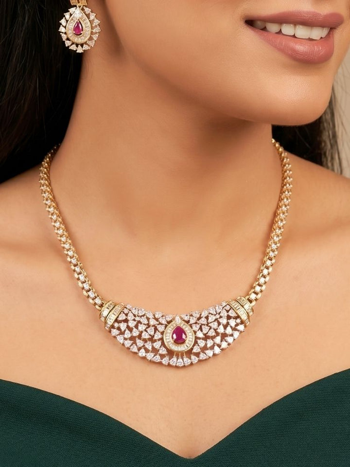 Close-up of a woman wearing an ornate Western (Silver Polish) Pink Collar jewellery set and earrings with Pink Colored Stone and American Diamond.Woman styling a statement American diamond necklace with an off-shoulder gown for a reception. Party wear outfit completed with a lightweight American diamond necklace.