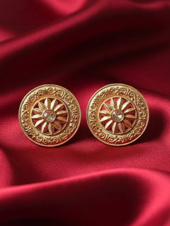 The Akhila Earrings are round gold stud earrings featuring a wheel shape design, with a central gemstone and Reverse American Diamond accents. Festive Diwali look styled with premium artificial Studs earrings. Close-up of anti-tarnish artificial Studs earrings for festive celebrations.