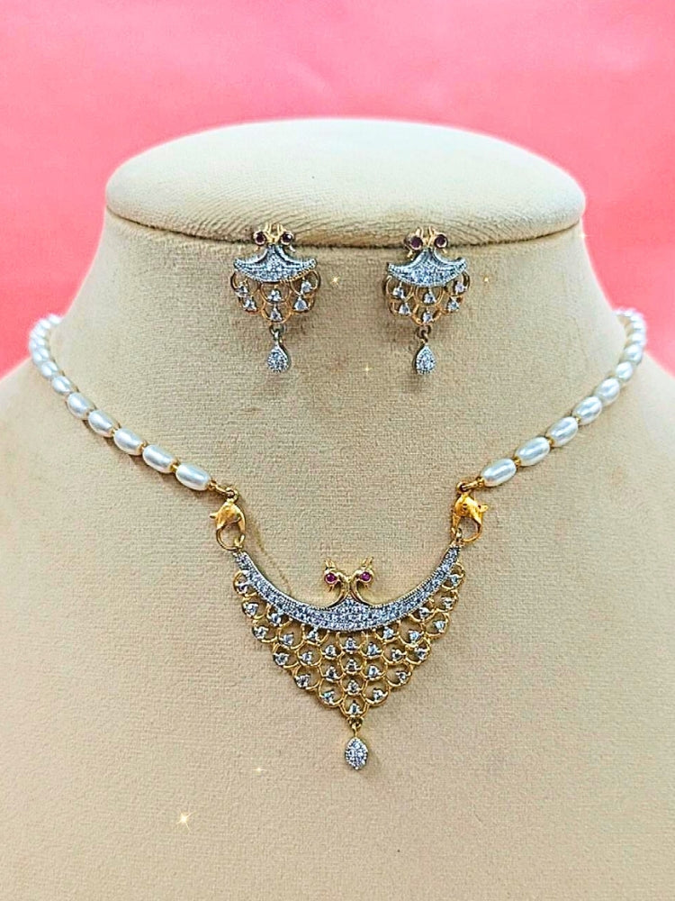 Akshita Mangalsutra—a gold necklace with black mangalsutra beads and matching earrings, pendant featuring sparkling American Diamonds—set against a cream dummy, perfect for your wedding ceremony dress. Diamond mangalsutra. Modern mangalsutra. 