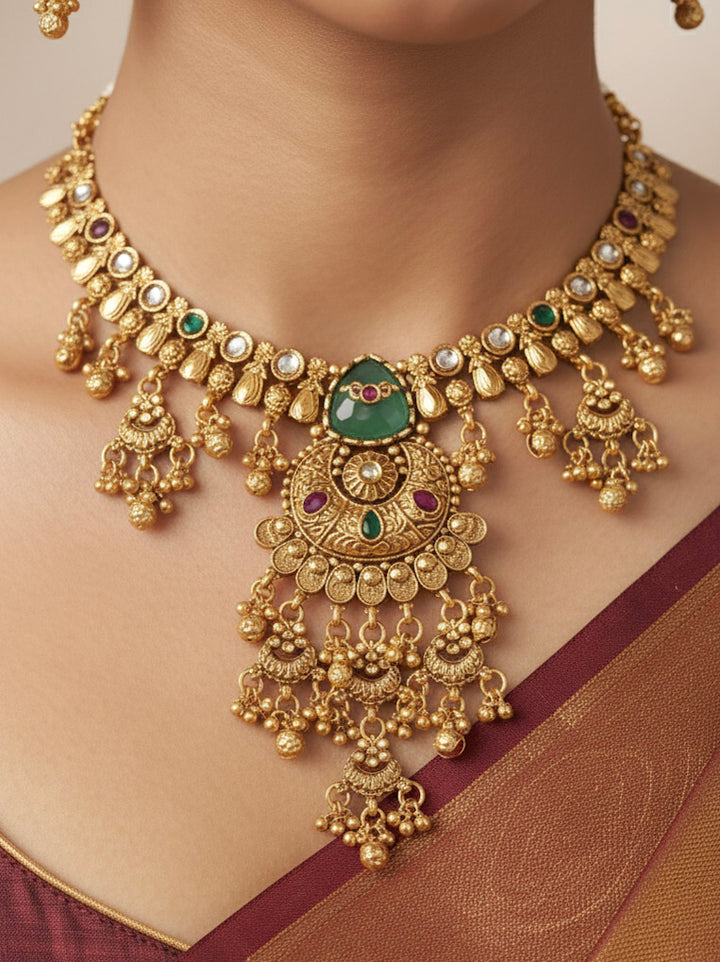 Close-up of a woman wearing an ornate traditional (Gold Polish) Mint Green Collar Haritage jewelry Set & Earrings with Color stones and kundan. Close-up of a royal heritage imitation jewelry set styled with a silk saree. Mehendi ceremony styling featuring a premium heritage artificial jewelry piece.