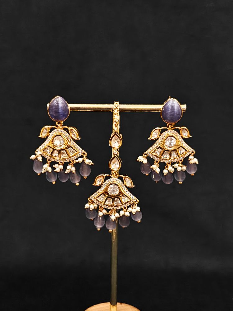 Close-up of an ornate traditional (Gold Polish) Lilac Choker jewellery set and earrings and maangtikka with Polki, Tumble Beads and Lilac Colored Stones. Woman wearing trending Polki artificial jewelry for the wedding season in India. Festive celebration look completed with premium imitation Polki jewelry.
