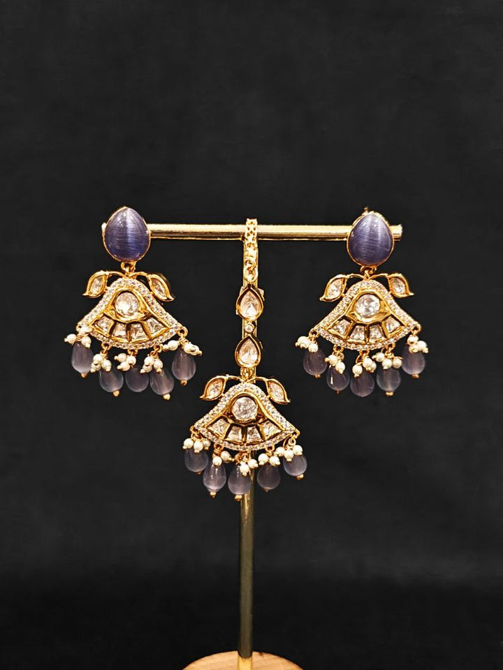 Close-up of an ornate traditional (Gold Polish) Lilac Choker jewellery set and earrings and maangtikka with Polki, Tumble Beads and Lilac Colored Stones. Woman wearing trending Polki artificial jewelry for the wedding season in India. Festive celebration look completed with premium imitation Polki jewelry.