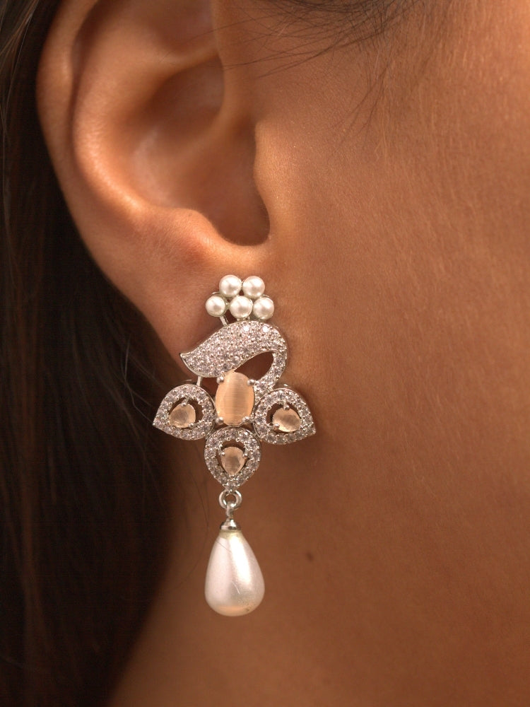 Close-up of a woman wearing an ornate Indo-western Peach (Silver Polish)  Pendant set and earrings with American Diamonds, Colored Stones and Pearls. Woman styling a statement American diamond Pendant with an off-shoulder gown for a reception. Indo-western outfit styled with a statement American diamond Pendant set.