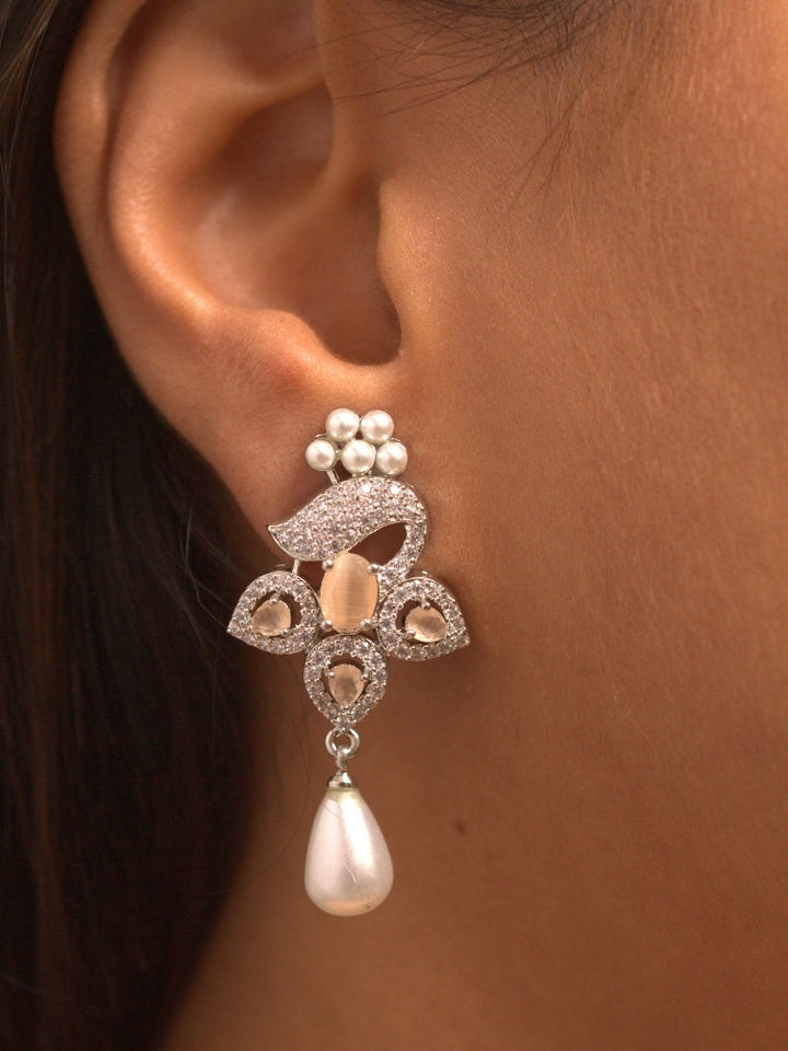 Close-up of a woman wearing an ornate Indo-western Peach (Silver Polish)  Pendant set and earrings with American Diamonds, Colored Stones and Pearls. Woman styling a statement American diamond Pendant with an off-shoulder gown for a reception. Indo-western outfit styled with a statement American diamond Pendant set.